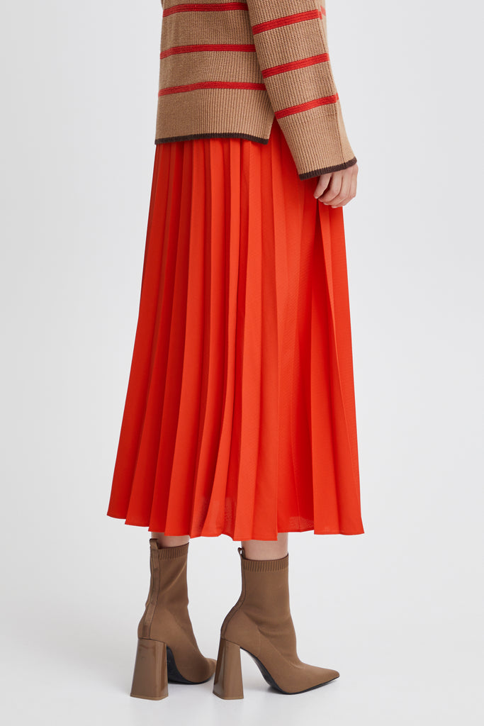 orange pleated skirt